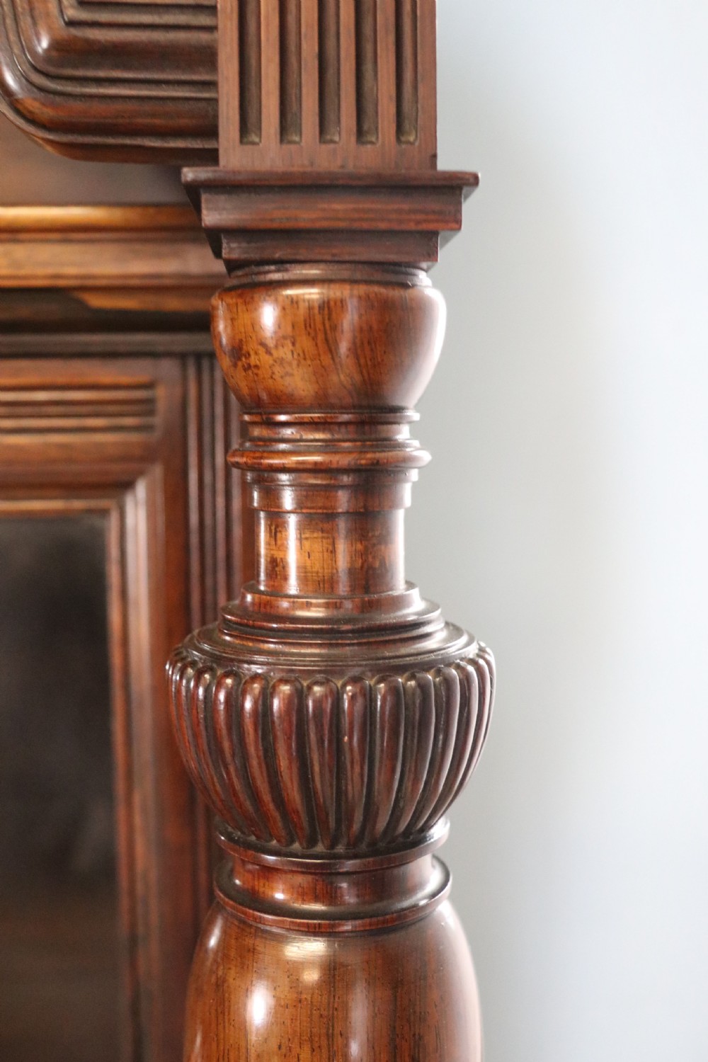 A large Victorian rosewood sideboard featuring an upper tier with arched alcoves, mirrors, and glazed cabinets over a lower base with drawers and panelled doors. View X