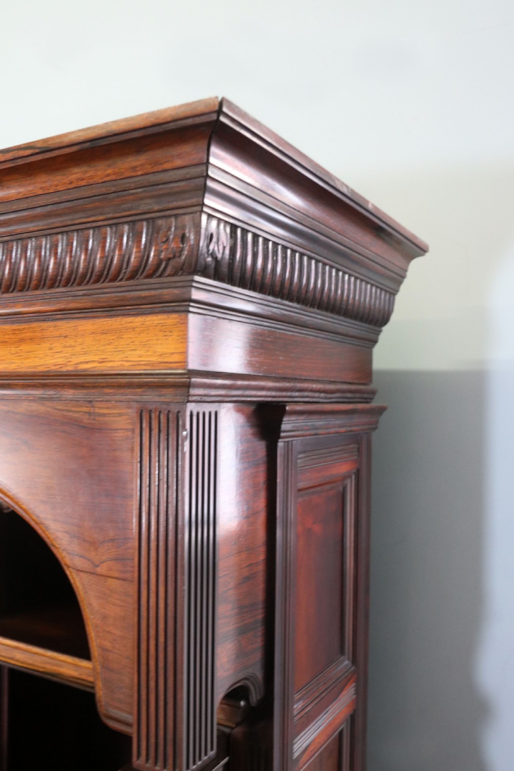 A large Victorian rosewood sideboard featuring an upper tier with arched alcoves, mirrors, and glazed cabinets over a lower base with drawers and panelled doors. View XII