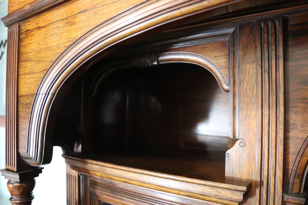 A large Victorian rosewood sideboard featuring an upper tier with arched alcoves, mirrors, and glazed cabinets over a lower base with drawers and panelled doors. View XIII