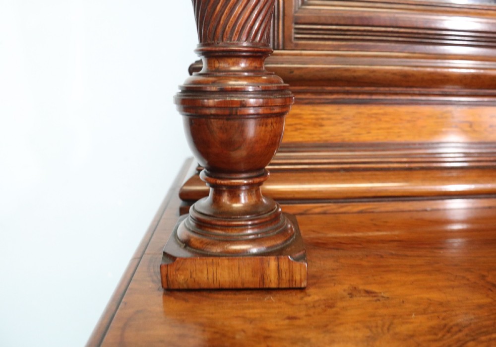 A large Victorian rosewood sideboard featuring an upper tier with arched alcoves, mirrors, and glazed cabinets over a lower base with drawers and panelled doors. View XV