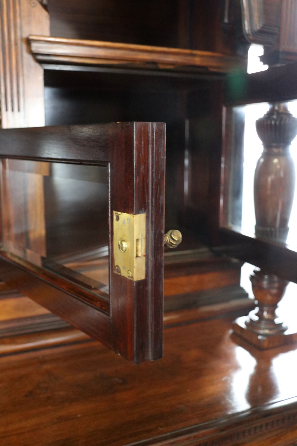 A large Victorian rosewood sideboard featuring an upper tier with arched alcoves, mirrors, and glazed cabinets over a lower base with drawers and panelled doors. View XVII