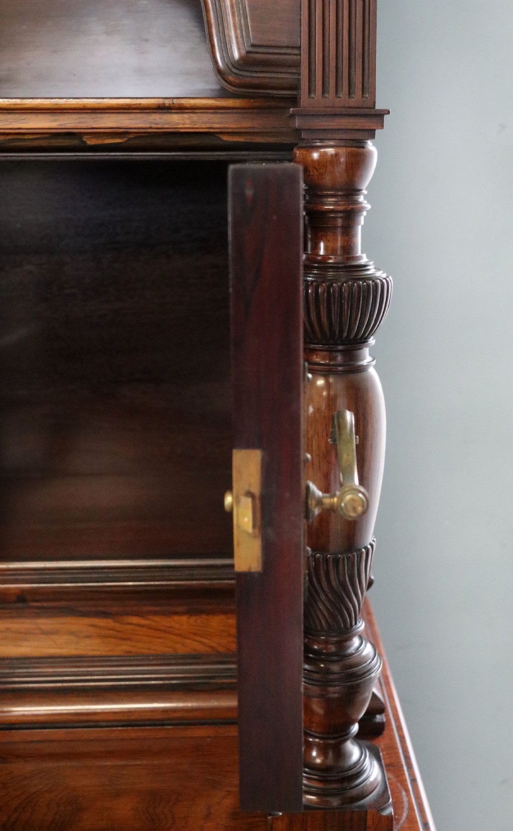 A large Victorian rosewood sideboard featuring an upper tier with arched alcoves, mirrors, and glazed cabinets over a lower base with drawers and panelled doors. View XVIII