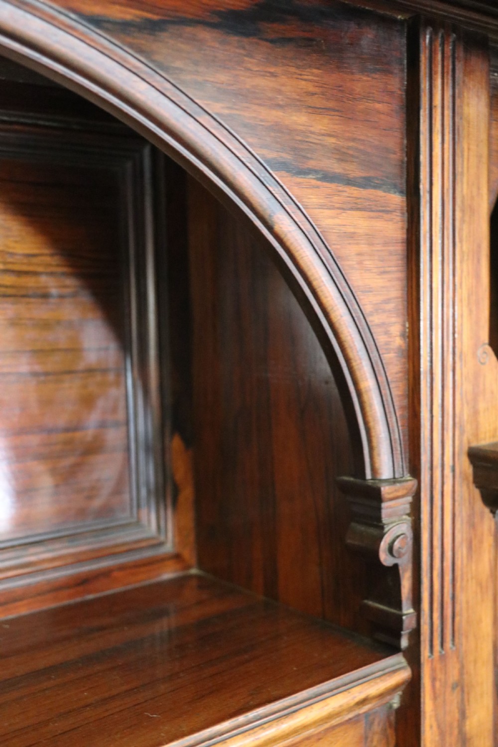 A large Victorian rosewood sideboard featuring an upper tier with arched alcoves, mirrors, and glazed cabinets over a lower base with drawers and panelled doors. View XX
