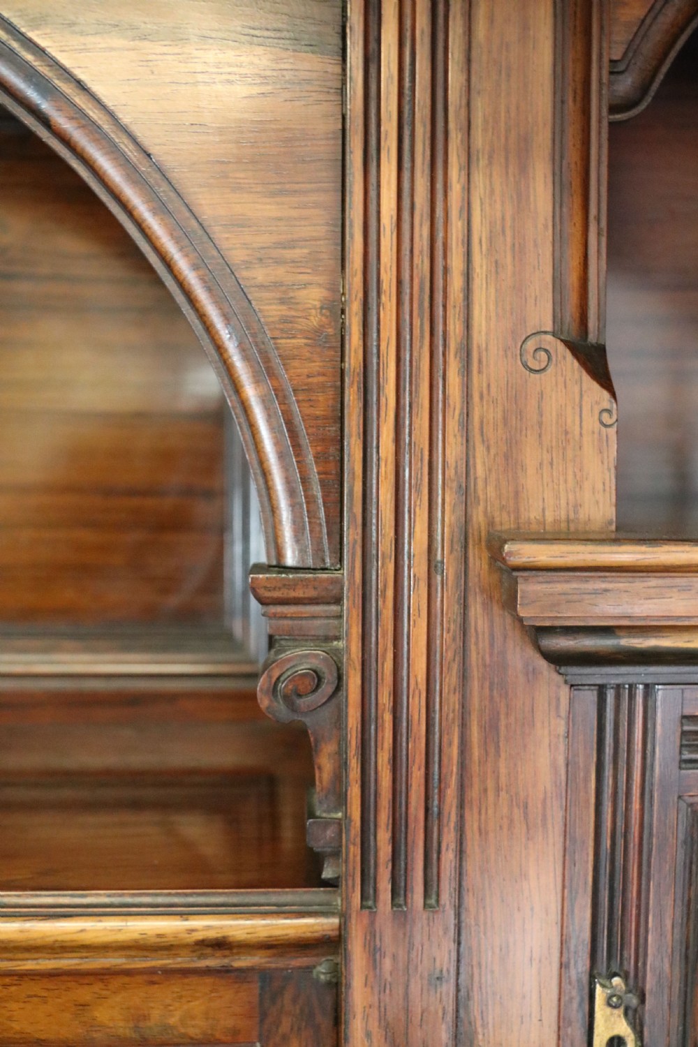 A large Victorian rosewood sideboard featuring an upper tier with arched alcoves, mirrors, and glazed cabinets over a lower base with drawers and panelled doors. View XXIII