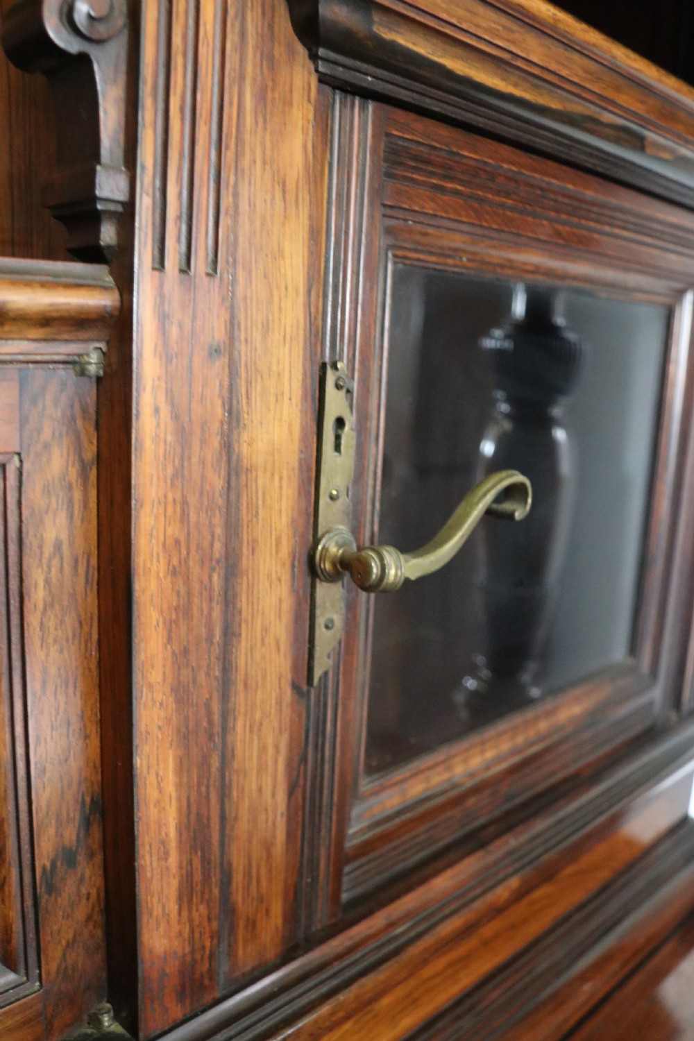 A large Victorian rosewood sideboard featuring an upper tier with arched alcoves, mirrors, and glazed cabinets over a lower base with drawers and panelled doors. View XXVI