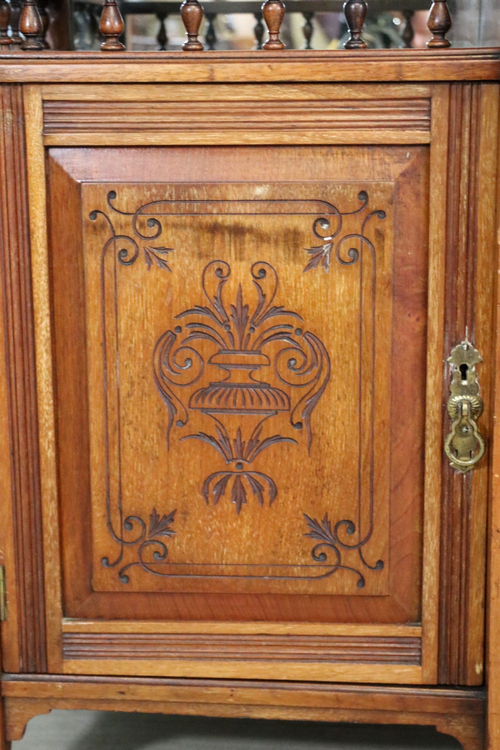 A late Victorian carved wood side cabinet featuring an ornate upper tier with multiple bevelled mirror plates, spindled galleries, glass-front doors, and carved lower cupboards. View XIX