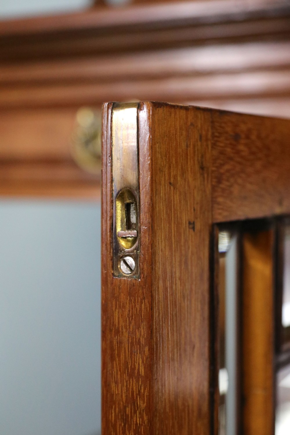 A late Victorian carved wood side cabinet featuring an ornate upper tier with multiple bevelled mirror plates, spindled galleries, glass-front doors, and carved lower cupboards. View XXI