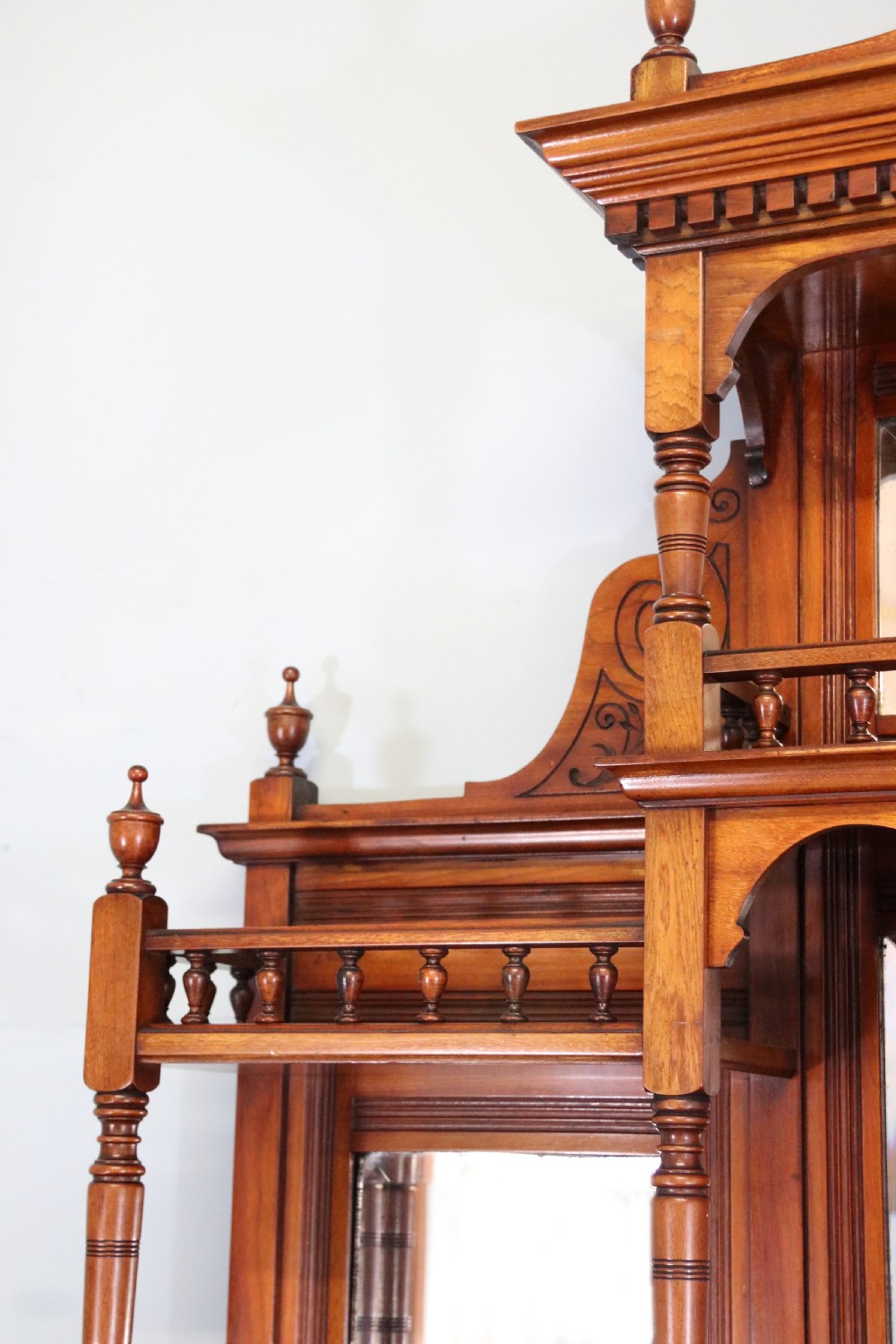A late Victorian carved wood side cabinet featuring an ornate upper tier with multiple bevelled mirror plates, spindled galleries, glass-front doors, and carved lower cupboards. View XXV