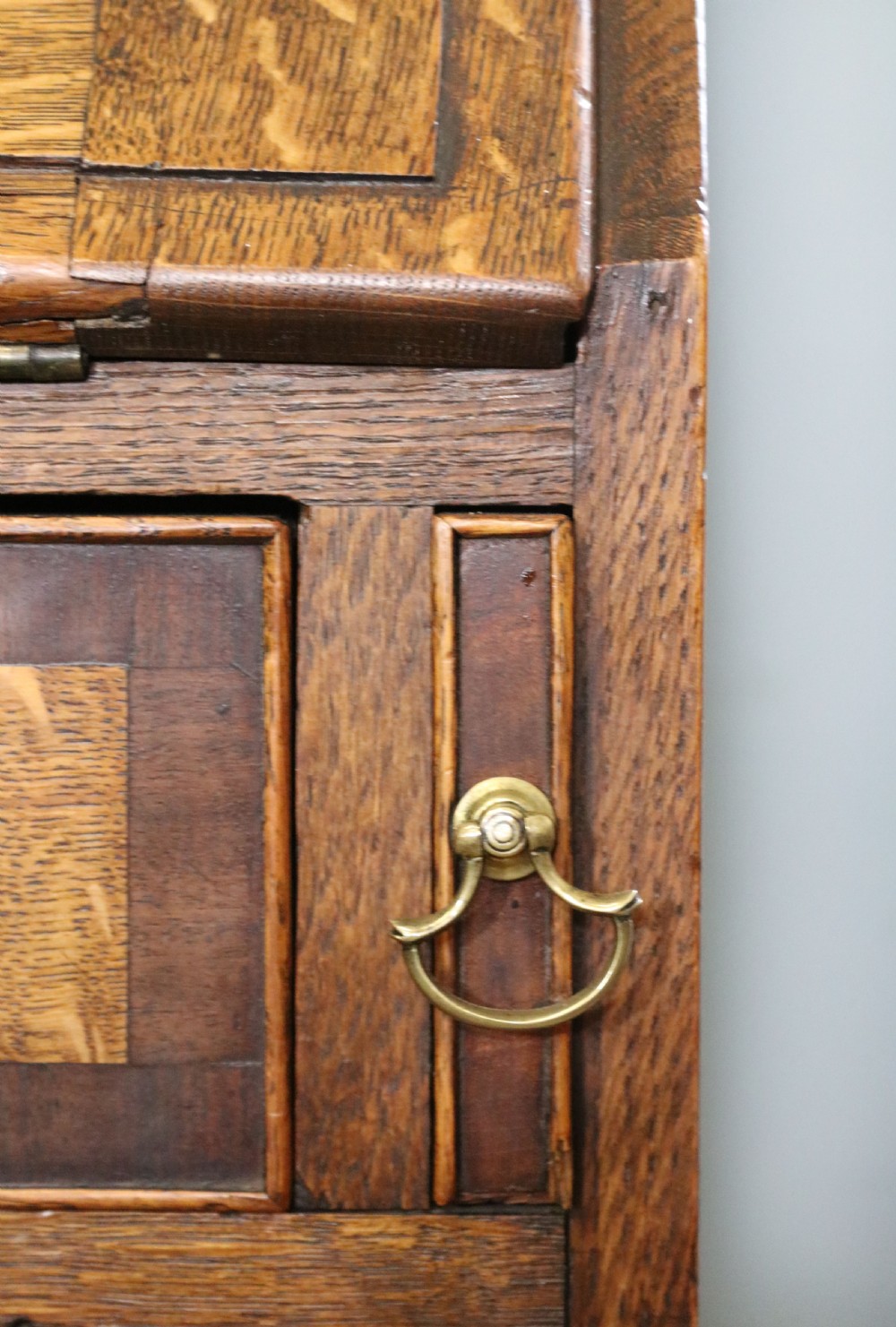 An open George III oak bureau featuring mahogany crossbanding, brass swan-neck handles, pull-out lopers, and a fitted interior with pigeonholes. View XIV