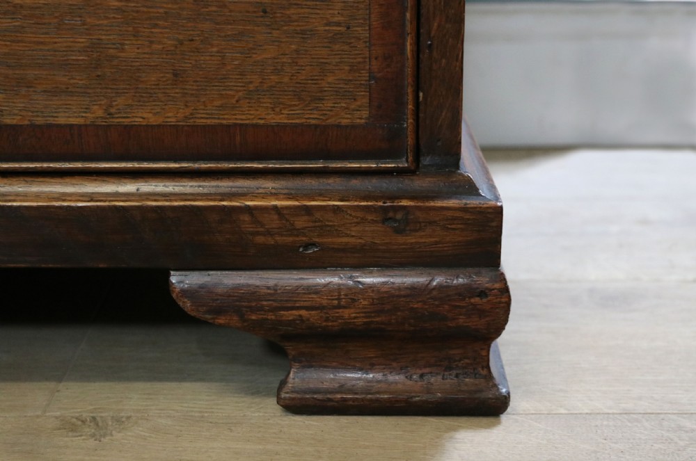 An open George III oak bureau featuring mahogany crossbanding, brass swan-neck handles, pull-out lopers, and a fitted interior with pigeonholes. View XX