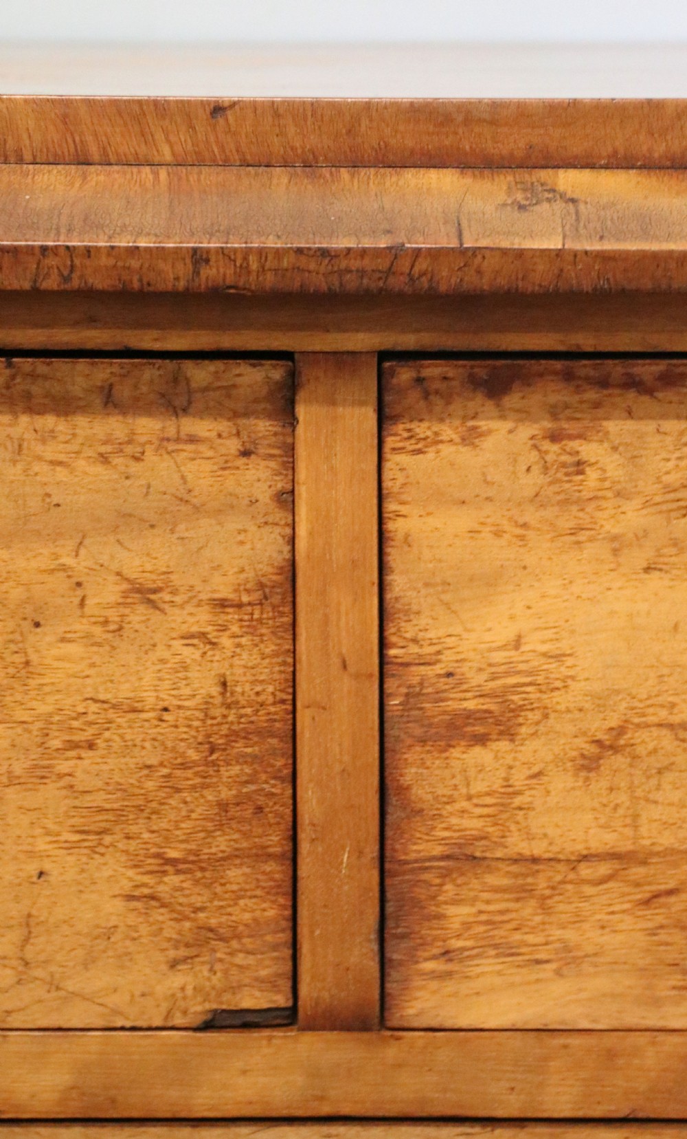 A Victorian light wood chest of drawers with two short drawers over three long drawers, featuring carved leaf handles and a solid plinth base. View VIII