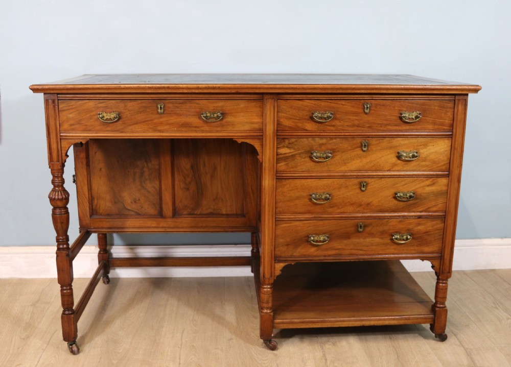 A lovely late 19th century aesthetic movement walnut desk