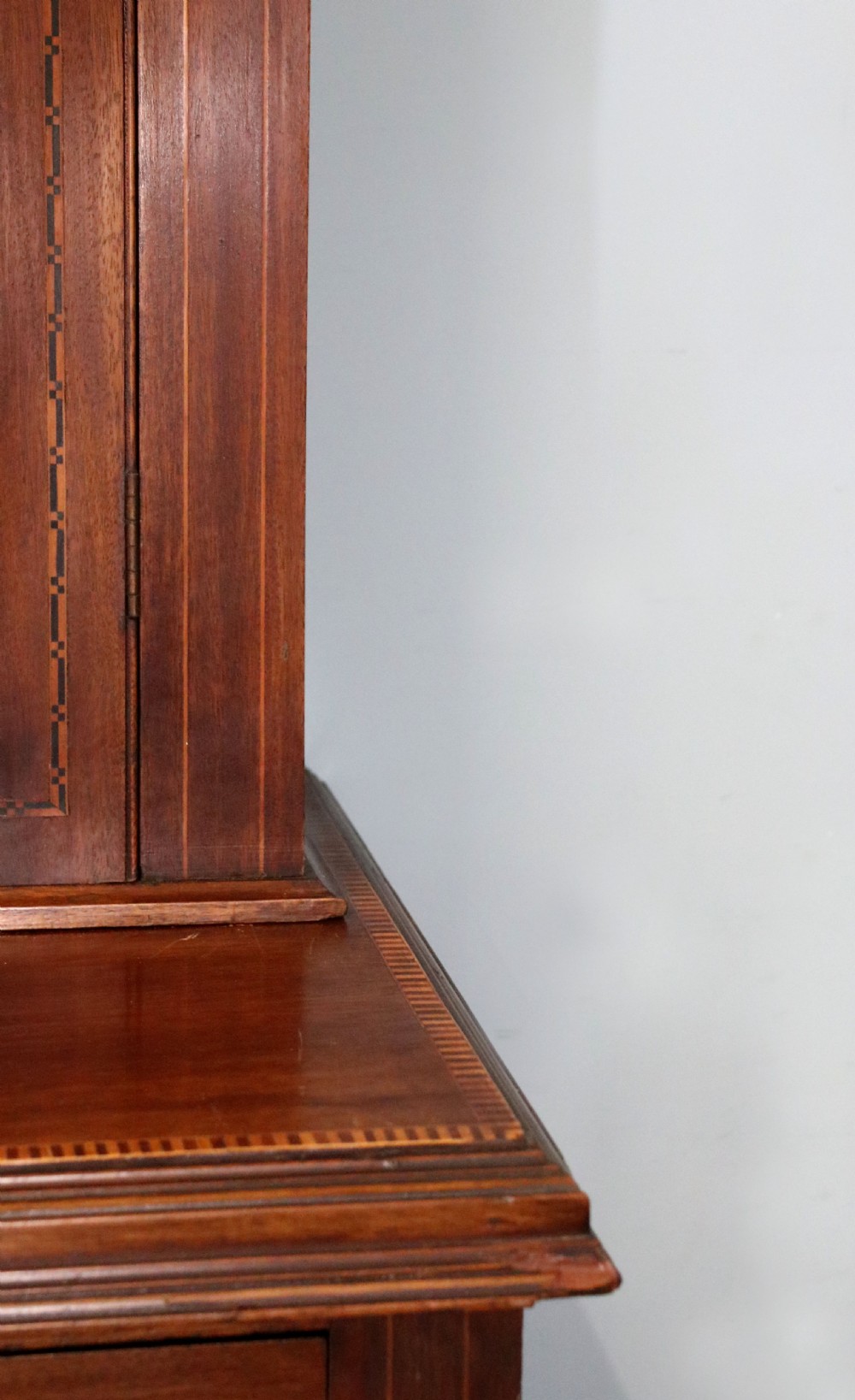 A late Victorian warm brown wooden cabinet featuring a glazed upper display section with white Jack Daniels typography and two lower panelled doors. View XVIII