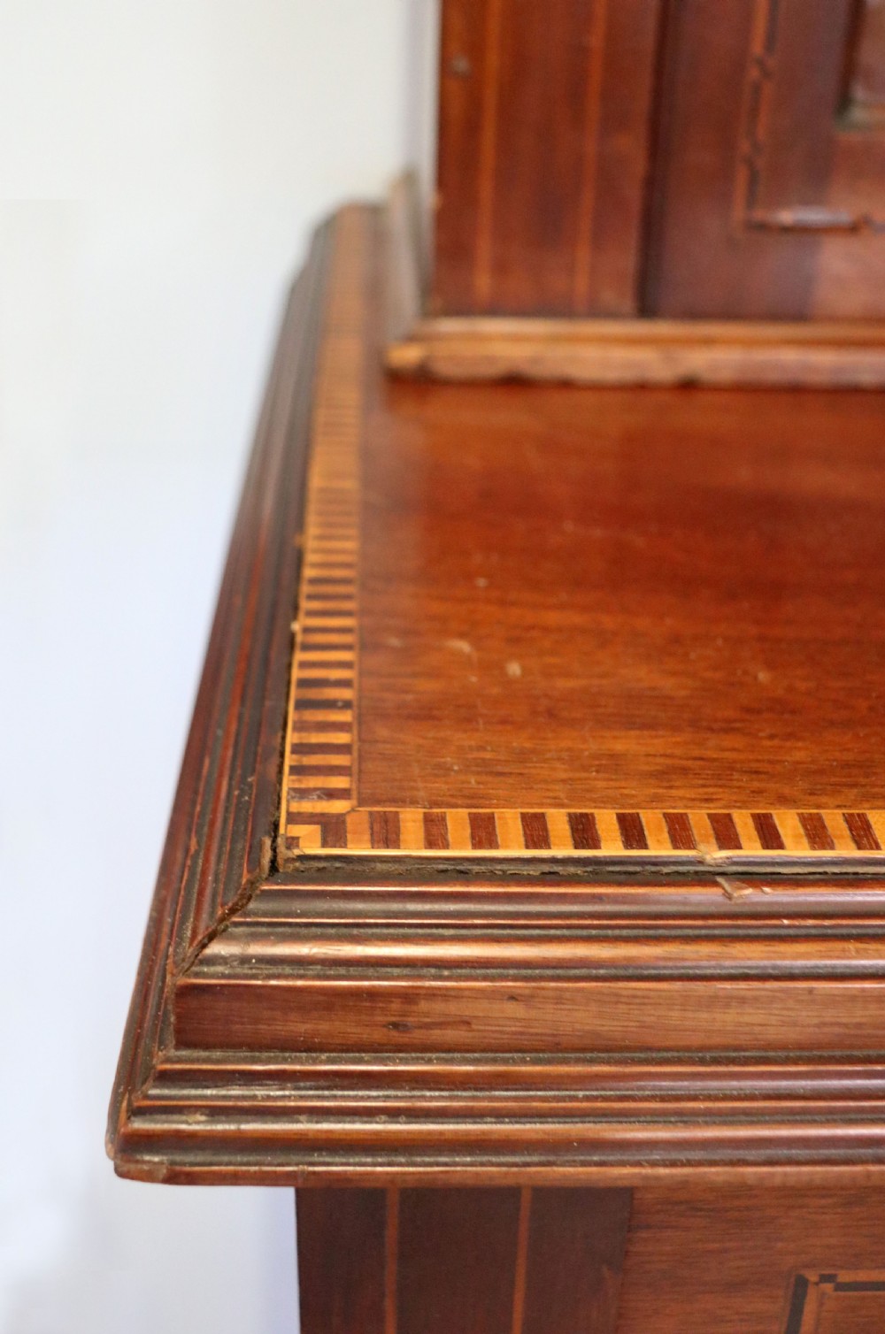 A late Victorian warm brown wooden cabinet featuring a glazed upper display section with white Jack Daniels typography and two lower panelled doors. View XIX