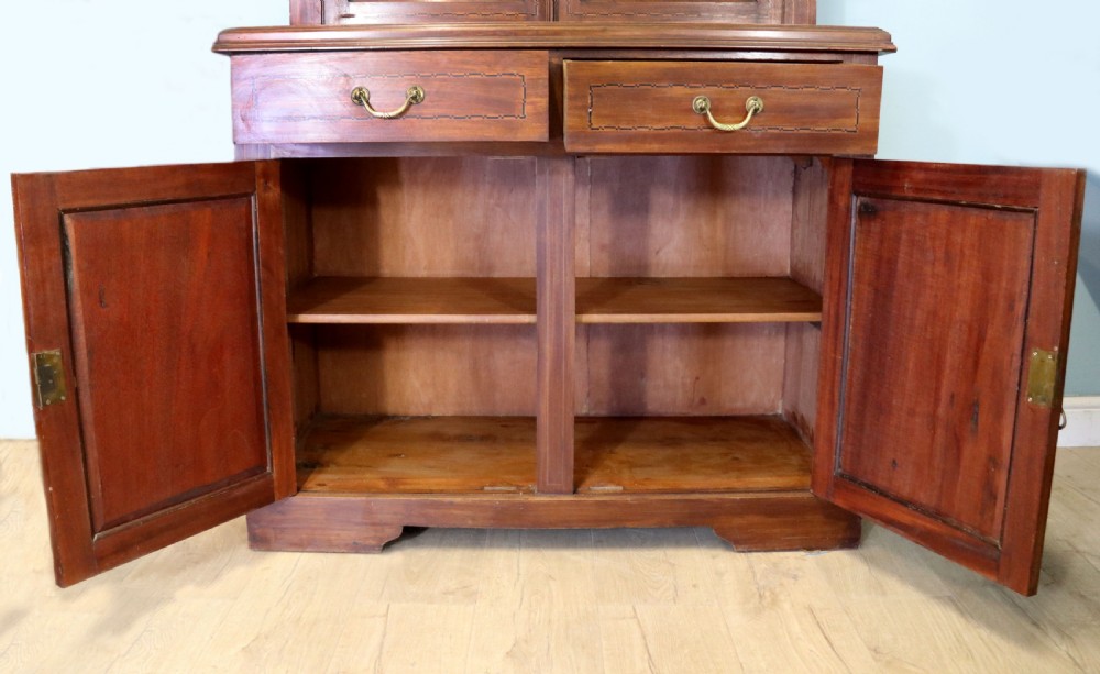 A late Victorian warm brown wooden cabinet featuring a glazed upper display section with white Jack Daniels typography and two lower panelled doors. View XXVI