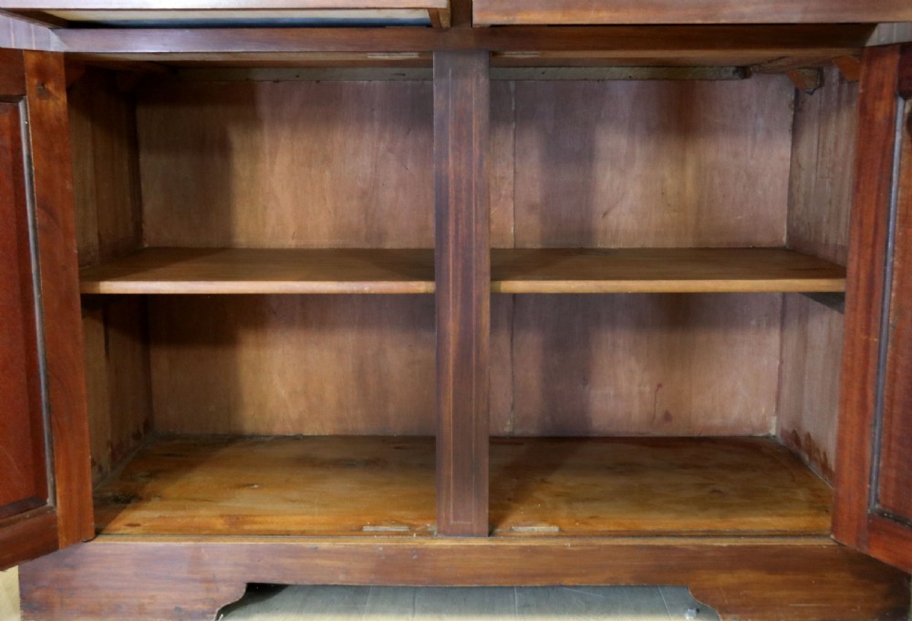 A late Victorian warm brown wooden cabinet featuring a glazed upper display section with white Jack Daniels typography and two lower panelled doors. View XXVII