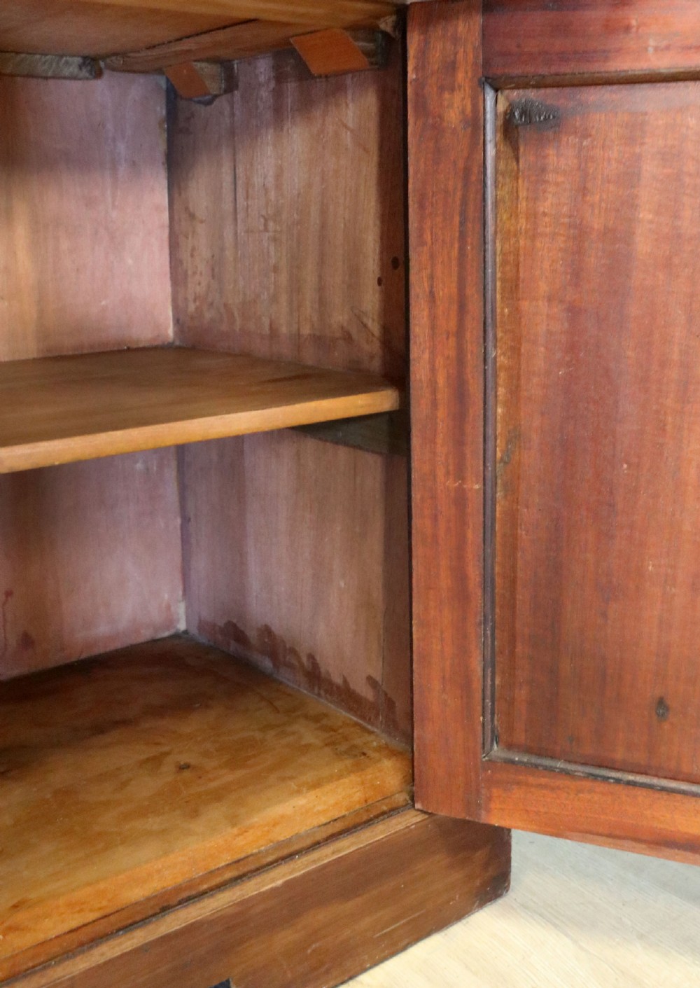 A late Victorian warm brown wooden cabinet featuring a glazed upper display section with white Jack Daniels typography and two lower panelled doors. View XXVIII