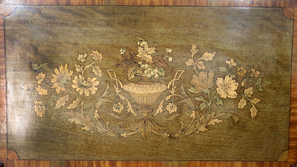 A late 19th-century mahogany display cabinet featuring a drop-centre mirror back, detailed floral marquetry inlays, glazed side doors, and a lower open shelf. View XVI
