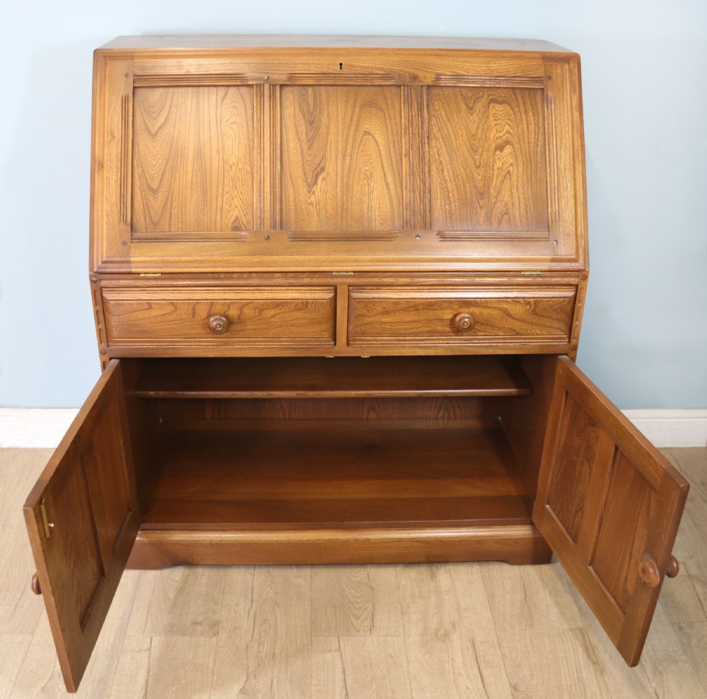  A lovely piece of modern Ercol light elm bureau. View V