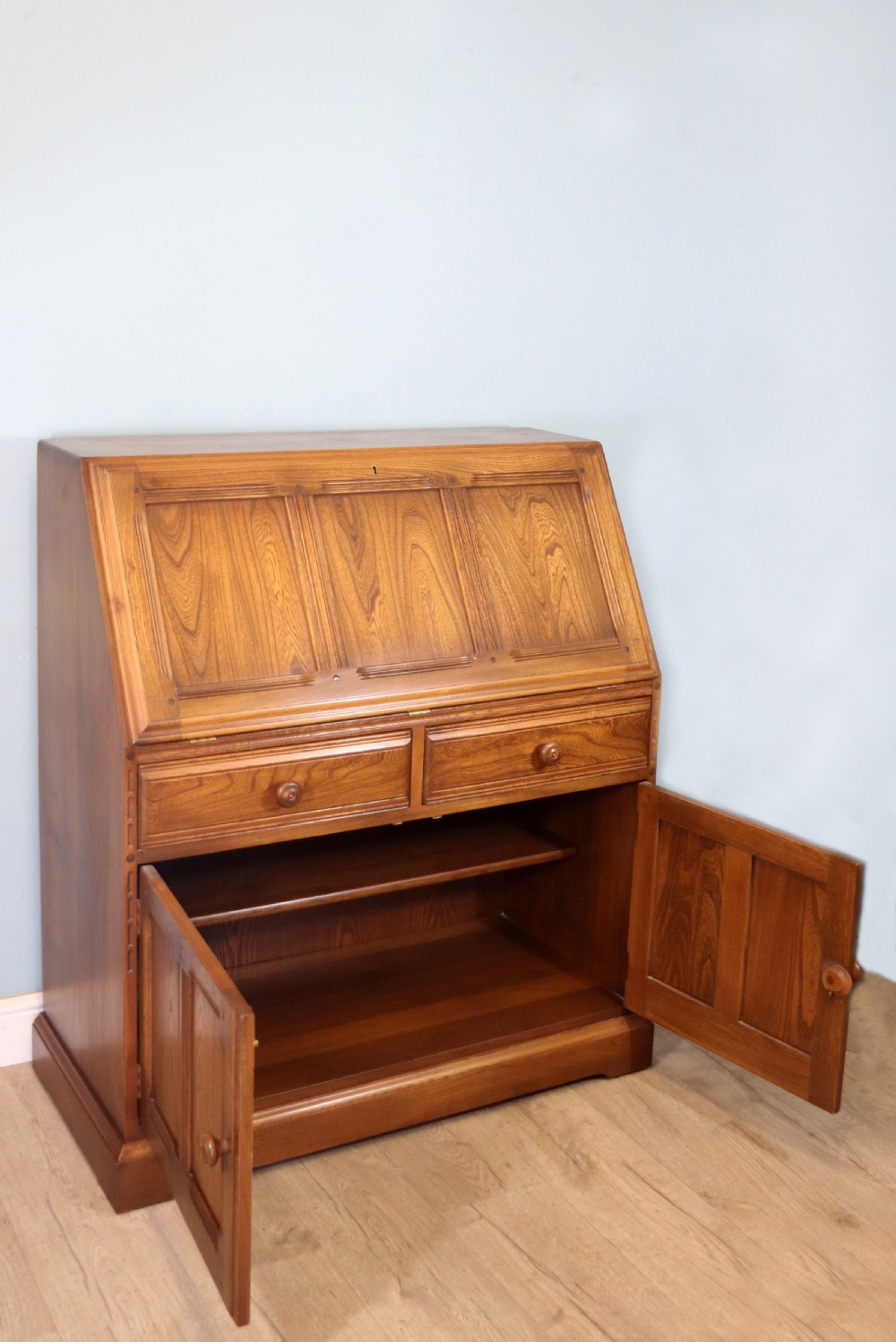  A lovely piece of modern Ercol light elm bureau. View IX