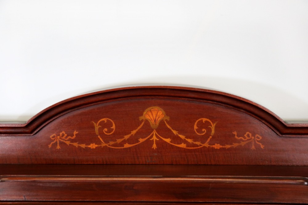 An Edwardian mahogany washstand featuring a red variegated marble top, a splashback set with green ceramic tiles, inlaid cupboard doors, and tapered legs. View VIII
