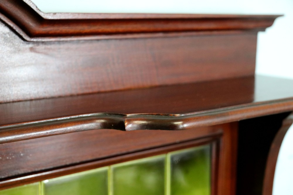 An Edwardian mahogany washstand featuring a red variegated marble top, a splashback set with green ceramic tiles, inlaid cupboard doors, and tapered legs. View XIII