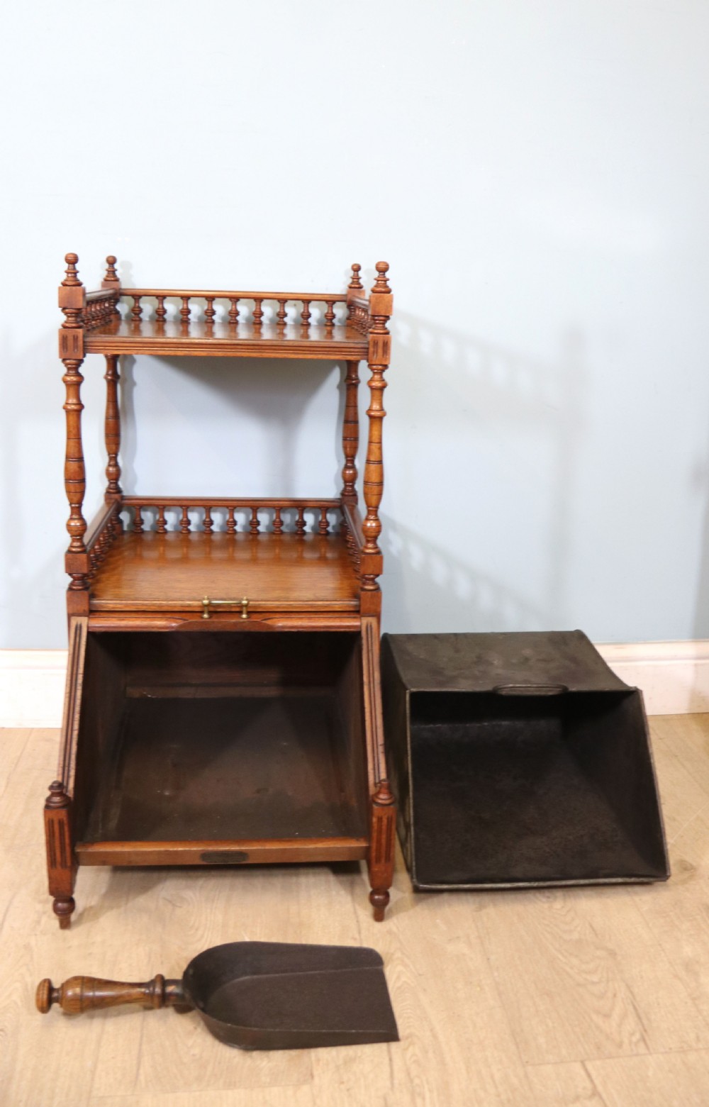 A Victorian Gothic Revival solid walnut coal purdonium featuring a carved drop-front compartment, turned spindle galleries, and upper open shelves. View III