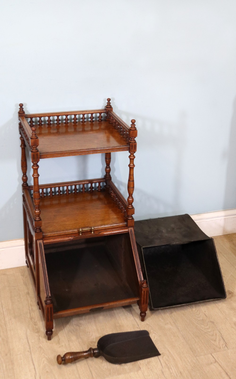 A Victorian Gothic Revival solid walnut coal purdonium featuring a carved drop-front compartment, turned spindle galleries, and upper open shelves. View VIII