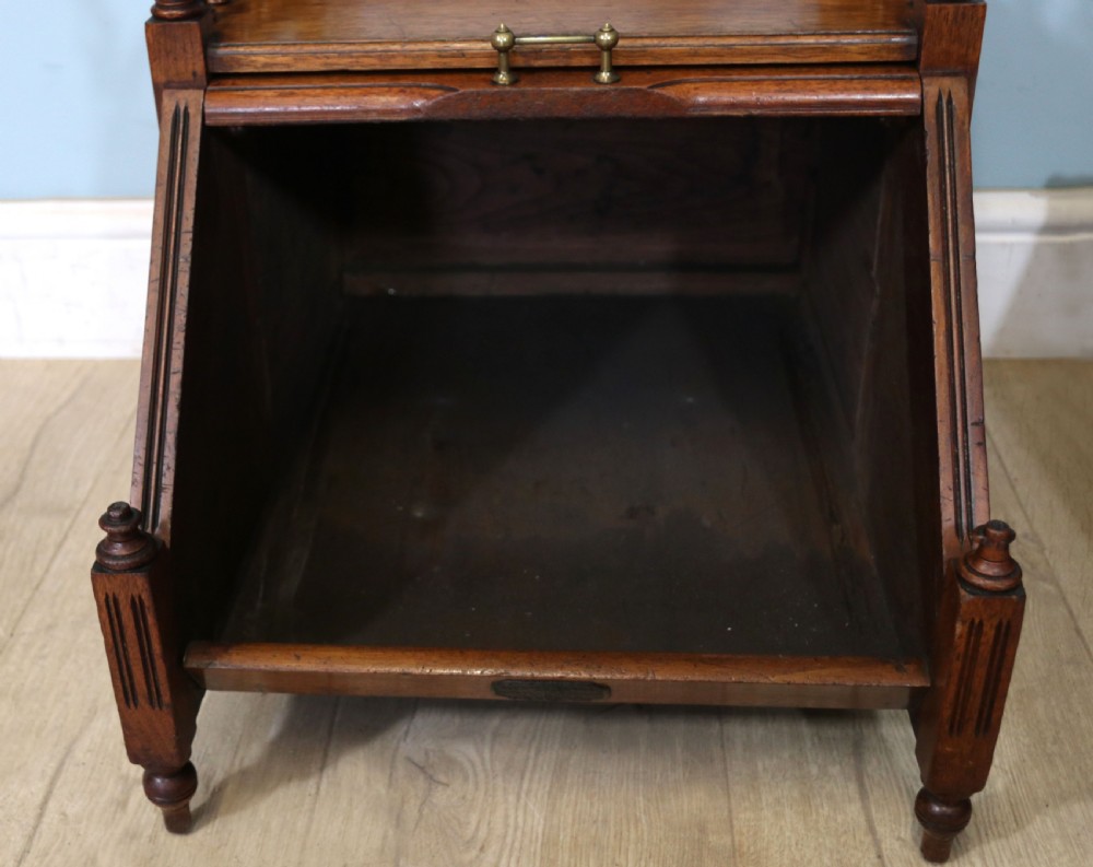 A Victorian Gothic Revival solid walnut coal purdonium featuring a carved drop-front compartment, turned spindle galleries, and upper open shelves. View XIV