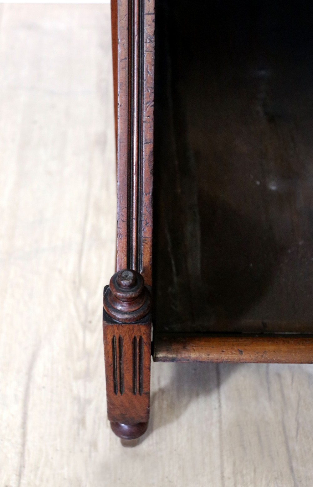 A Victorian Gothic Revival solid walnut coal purdonium featuring a carved drop-front compartment, turned spindle galleries, and upper open shelves. View XV