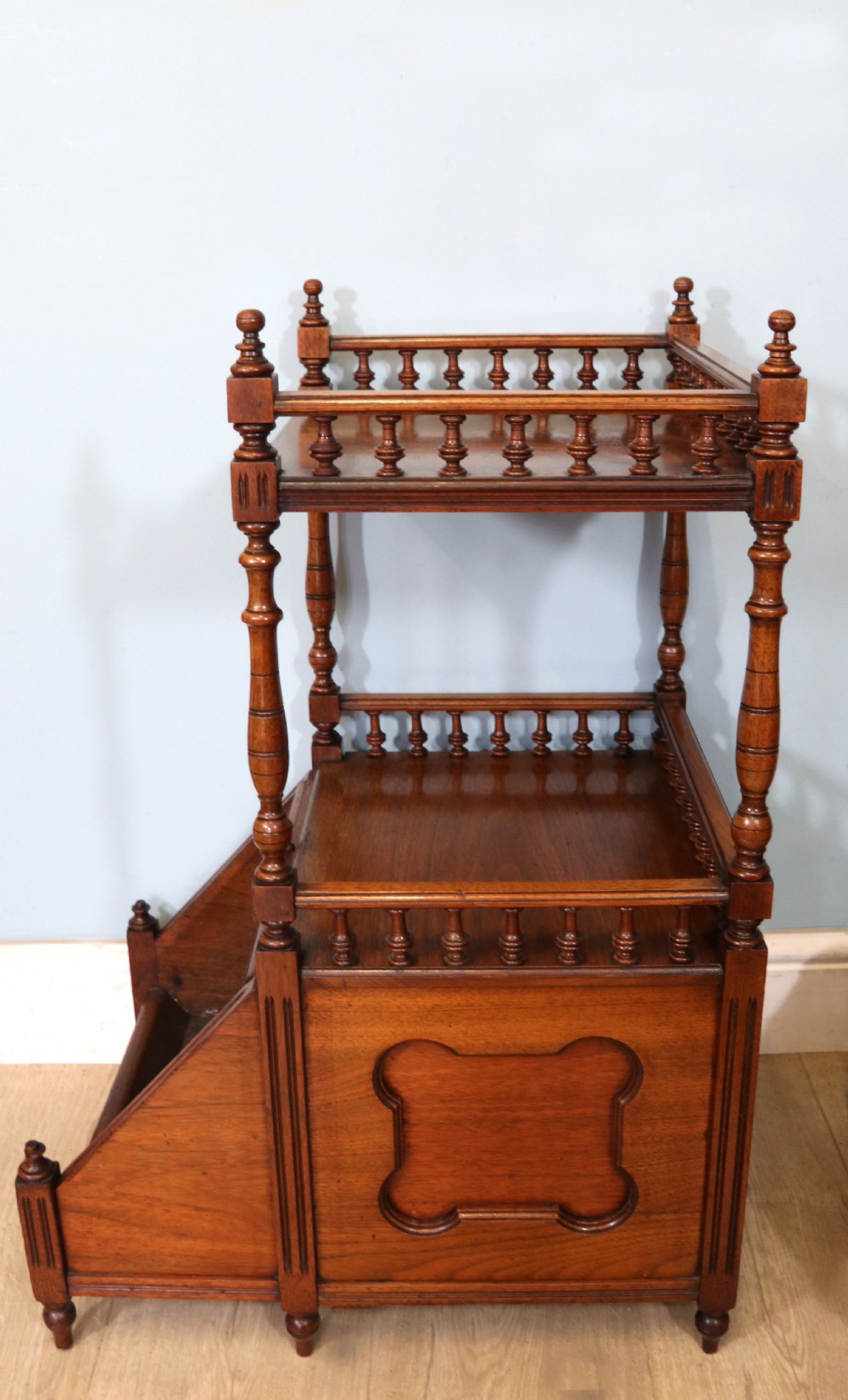 A Victorian Gothic Revival solid walnut coal purdonium featuring a carved drop-front compartment, turned spindle galleries, and upper open shelves. View XX