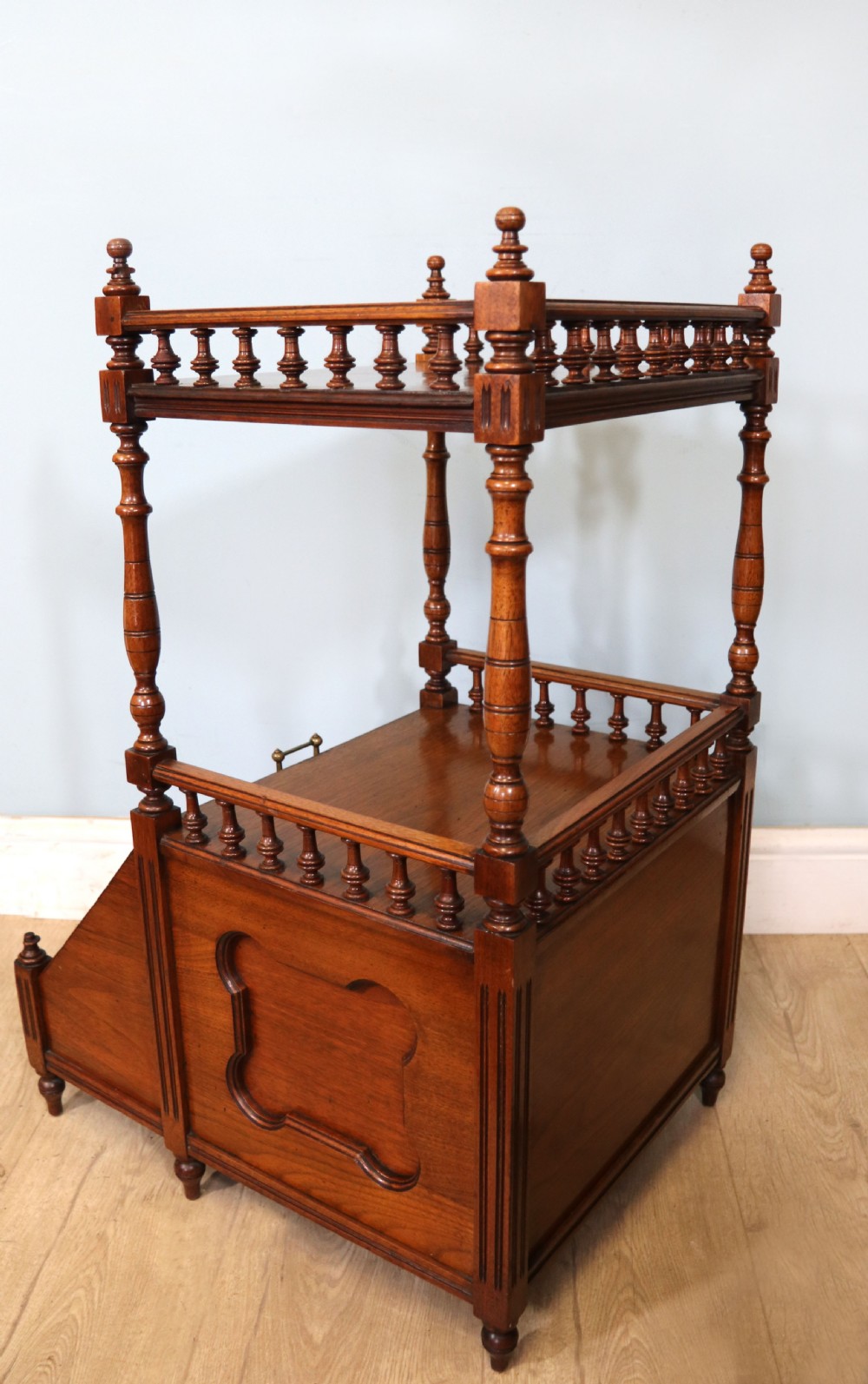 A Victorian Gothic Revival solid walnut coal purdonium featuring a carved drop-front compartment, turned spindle galleries, and upper open shelves. View XXI