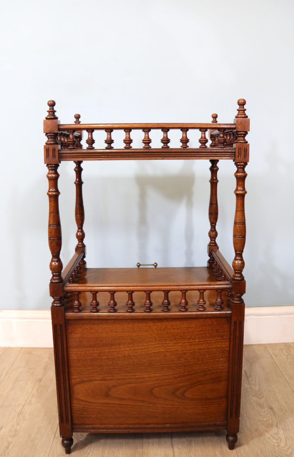 A Victorian Gothic Revival solid walnut coal purdonium featuring a carved drop-front compartment, turned spindle galleries, and upper open shelves. View XXII