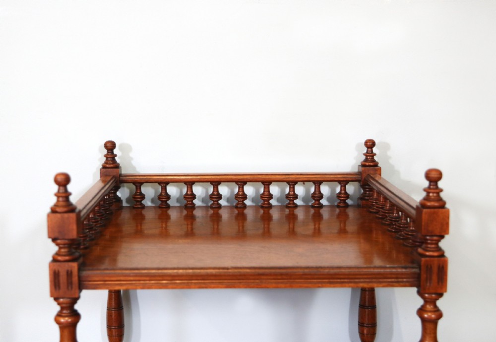 A Victorian Gothic Revival solid walnut coal purdonium featuring a carved drop-front compartment, turned spindle galleries, and upper open shelves. View XXIII