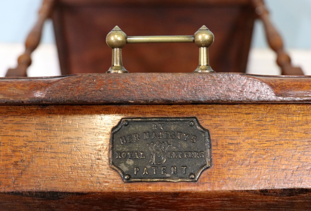 A Victorian Gothic Revival solid walnut coal purdonium featuring a carved drop-front compartment, turned spindle galleries, and upper open shelves. View XXVIII