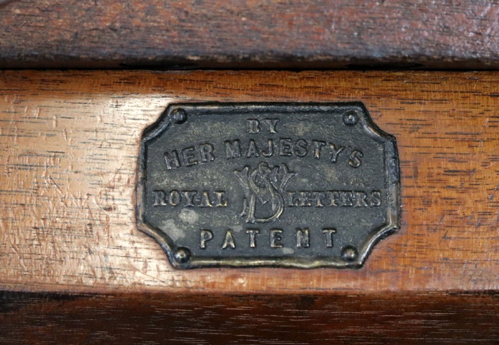 A Victorian Gothic Revival solid walnut coal purdonium featuring a carved drop-front compartment, turned spindle galleries, and upper open shelves. View XXIX