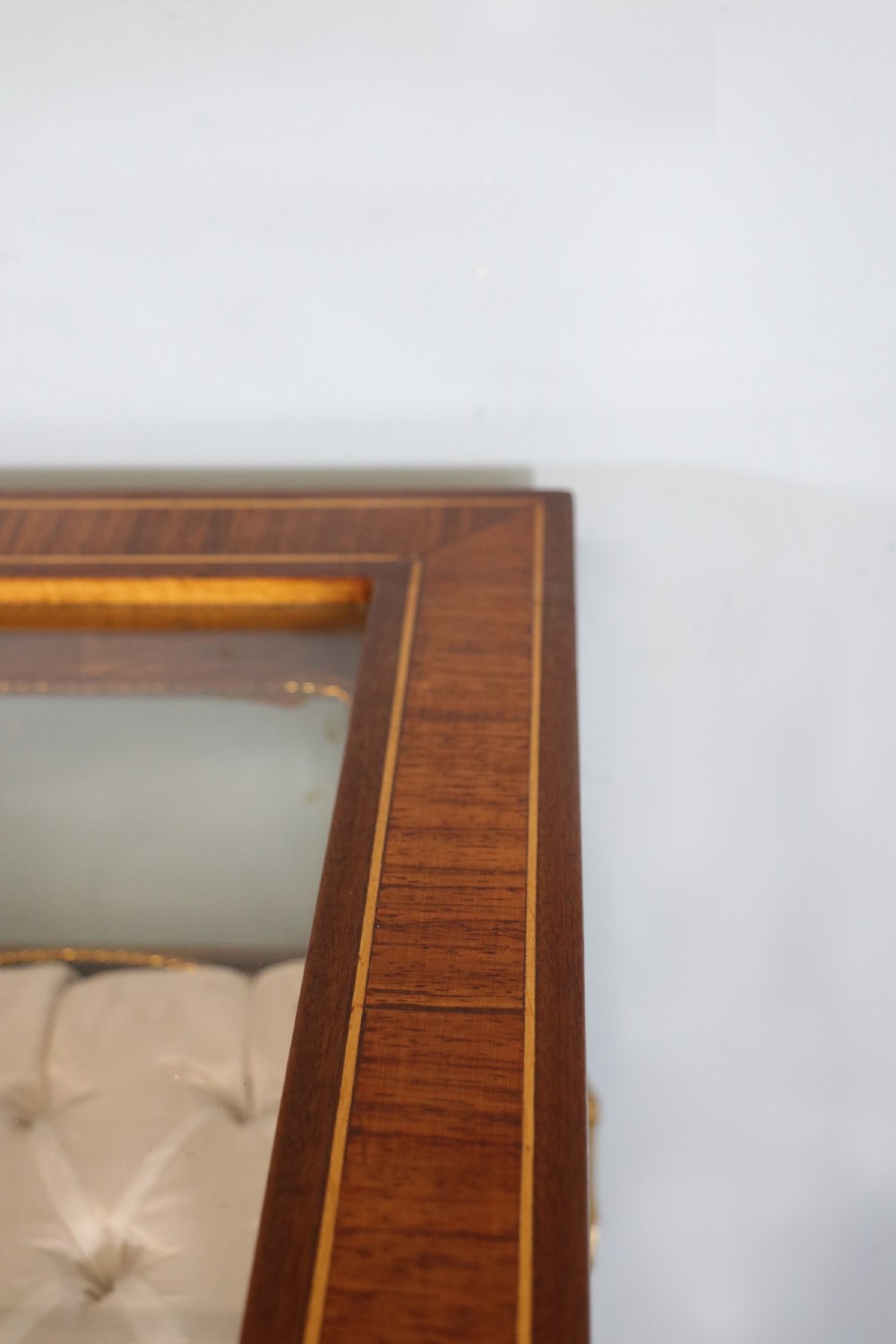 A mahogany and kingwood veneered bijouterie display table featuring glazed panels, cabriole legs with brass mounts, and a buttoned cream interior. View VIII