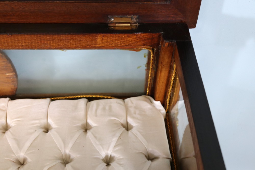 A mahogany and kingwood veneered bijouterie display table featuring glazed panels, cabriole legs with brass mounts, and a buttoned cream interior. View XII