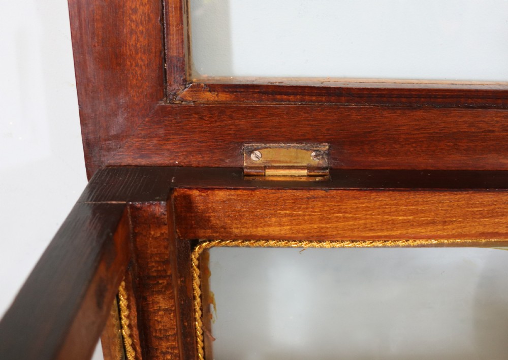 A mahogany and kingwood veneered bijouterie display table featuring glazed panels, cabriole legs with brass mounts, and a buttoned cream interior. View XIV