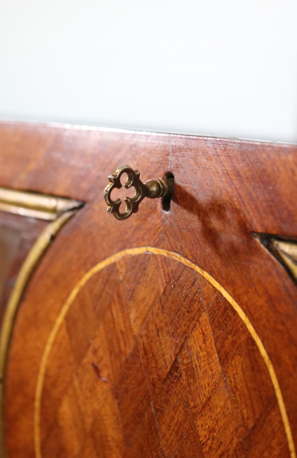 A mahogany and kingwood veneered bijouterie display table featuring glazed panels, cabriole legs with brass mounts, and a buttoned cream interior. View XVII