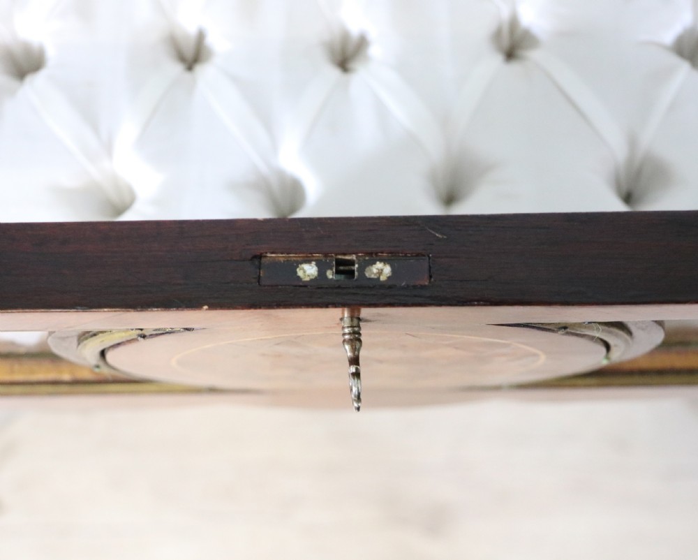 A mahogany and kingwood veneered bijouterie display table featuring glazed panels, cabriole legs with brass mounts, and a buttoned cream interior. View XVIII