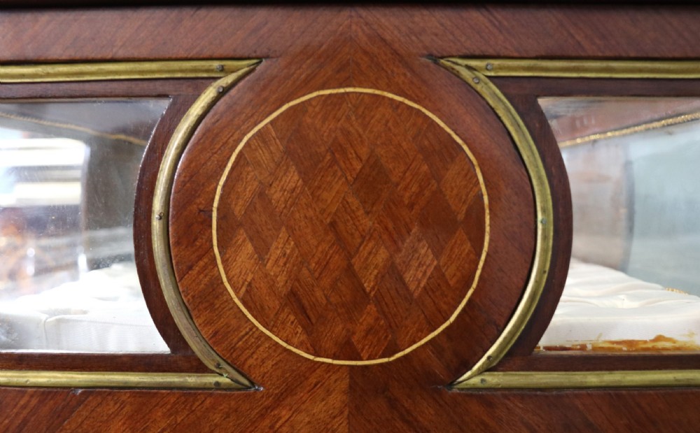 A mahogany and kingwood veneered bijouterie display table featuring glazed panels, cabriole legs with brass mounts, and a buttoned cream interior. View XXII