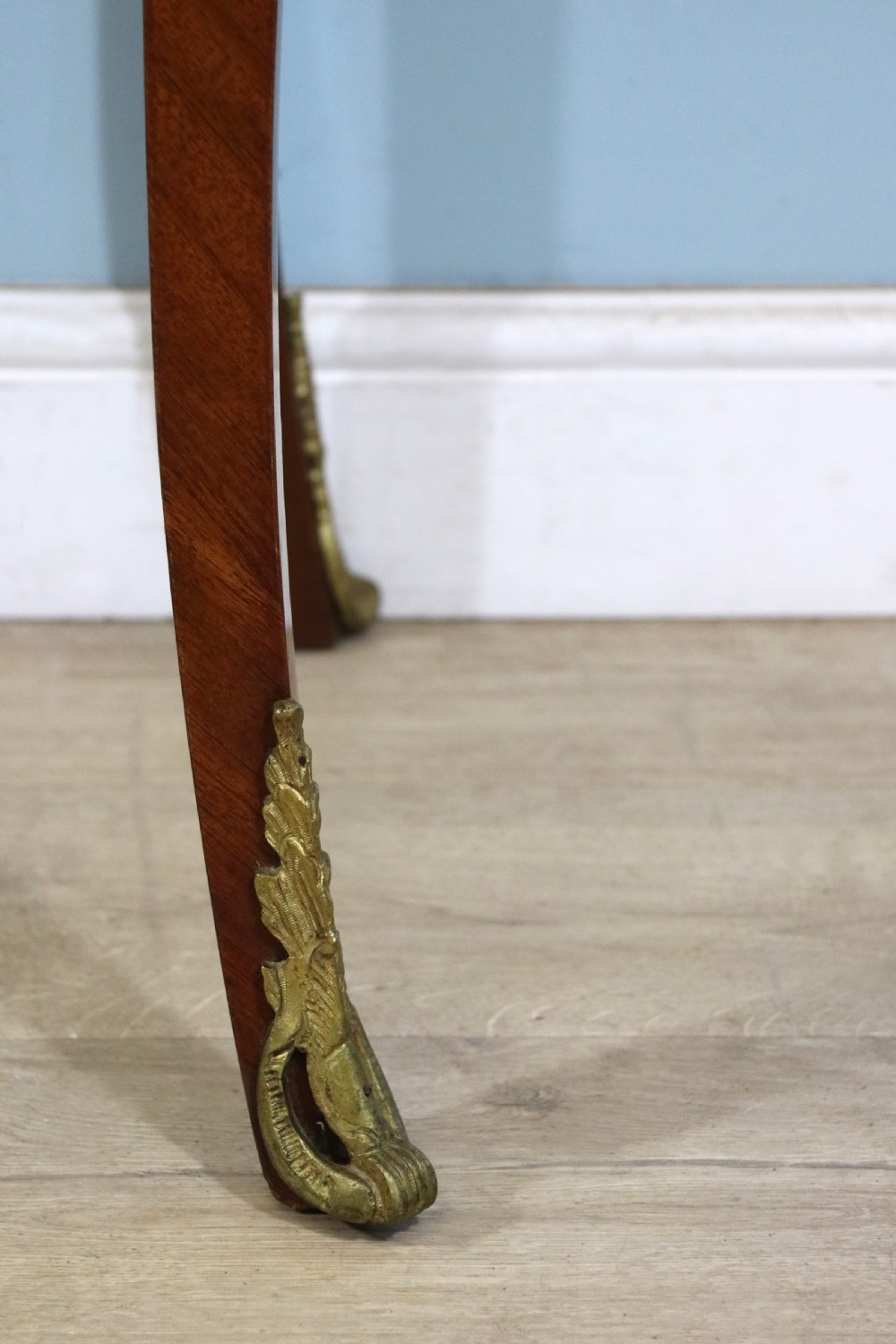 A mahogany and kingwood veneered bijouterie display table featuring glazed panels, cabriole legs with brass mounts, and a buttoned cream interior. View XXV