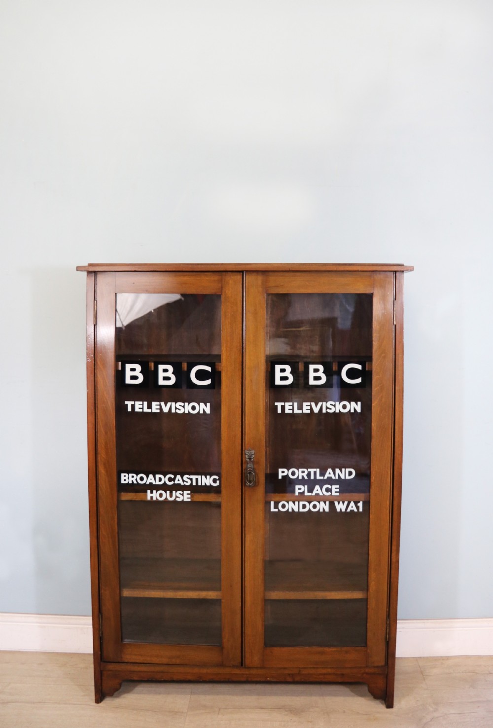A mid-century glazed two door bookcase cabinet.