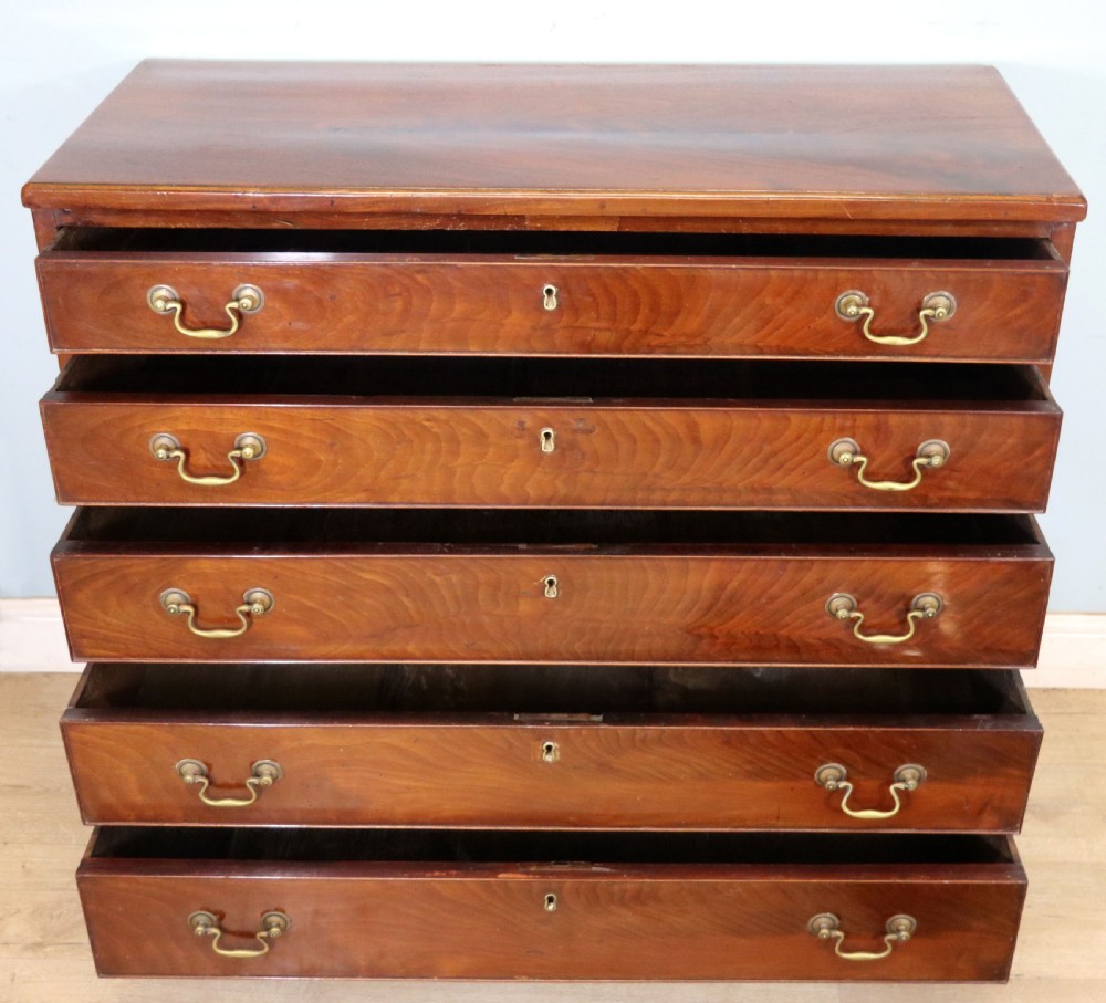 A 19th-century mahogany chest of drawers featuring five graduated drawers with brass swan-neck handles and bracket feet. View III