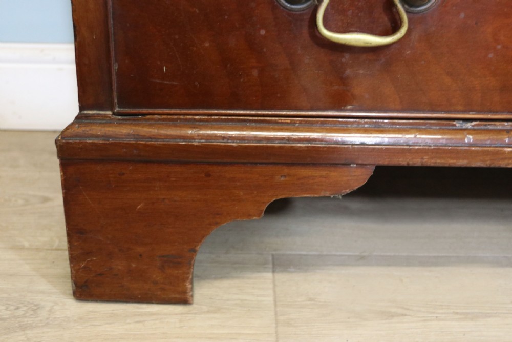 A 19th-century mahogany chest of drawers featuring five graduated drawers with brass swan-neck handles and bracket feet. View XIII
