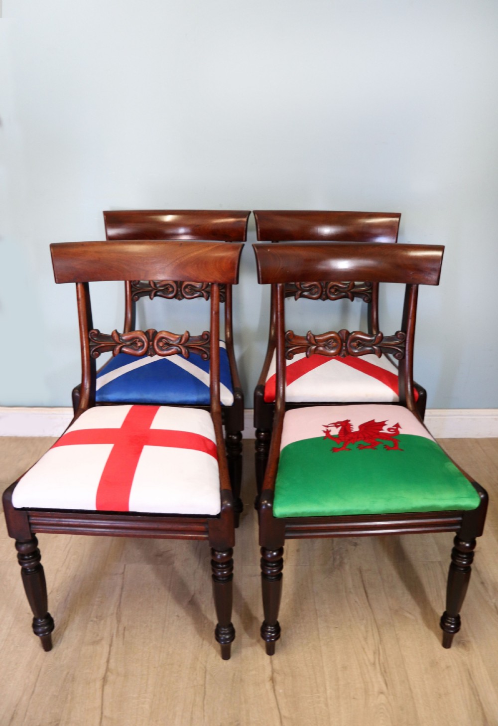 A set of four Victorian mahogany bar-back dining chairs with carved mid-rails, turned front legs, and flag-patterned upholstered seats. View II