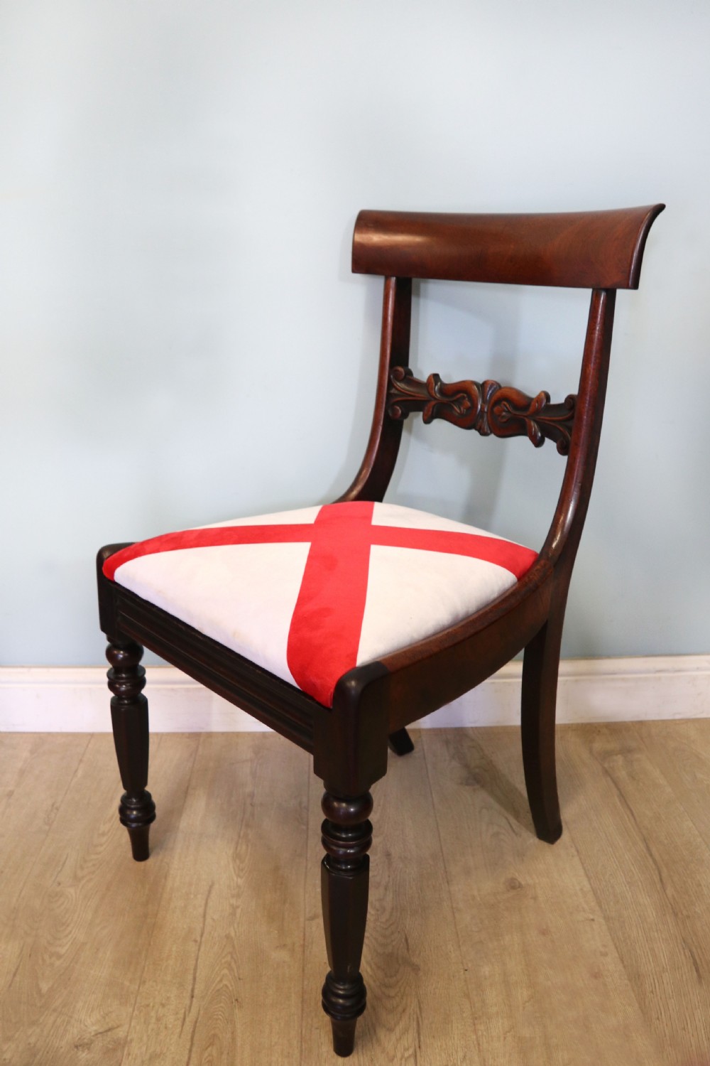 A set of four Victorian mahogany bar-back dining chairs with carved mid-rails, turned front legs, and flag-patterned upholstered seats. View V