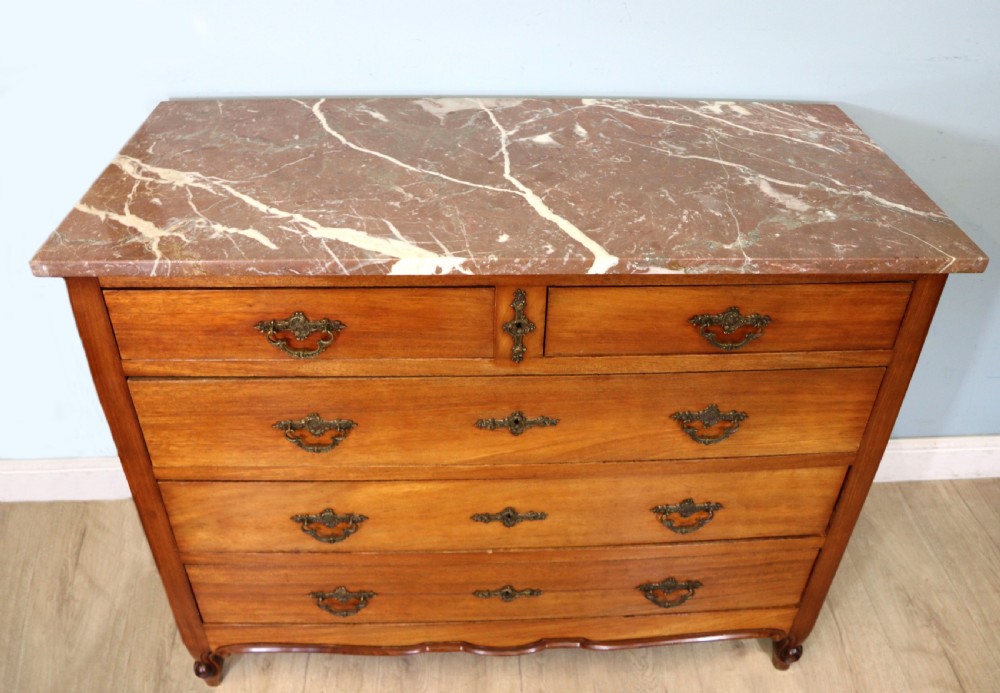 A lovely late 19th century French walnut marble topped chest.
