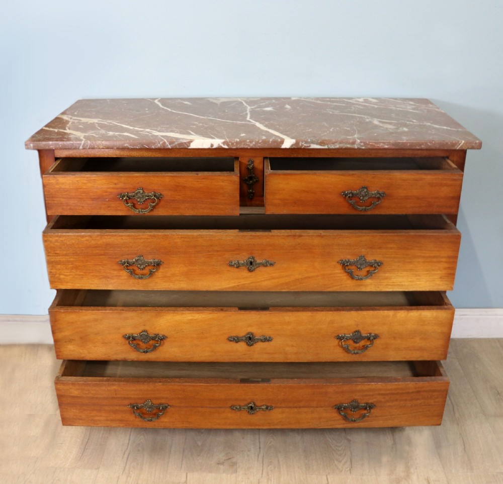 A lovely late 19th century French walnut marble topped chest. View II